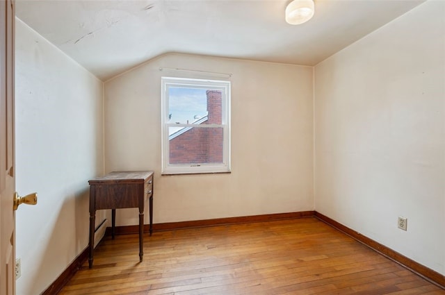 bonus room with lofted ceiling and light hardwood / wood-style floors