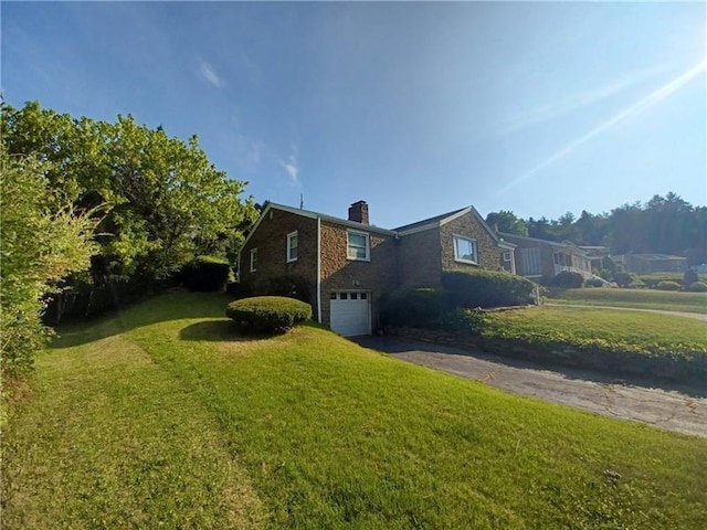 view of side of home with a garage and a yard