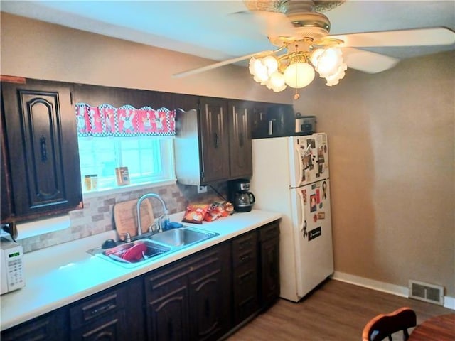 kitchen with ceiling fan, sink, dark hardwood / wood-style floors, and white fridge