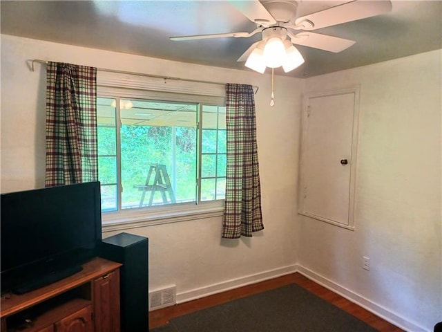 interior space with ceiling fan and dark hardwood / wood-style flooring