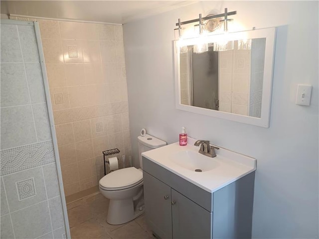 bathroom featuring toilet, vanity, tile walls, and tile patterned floors