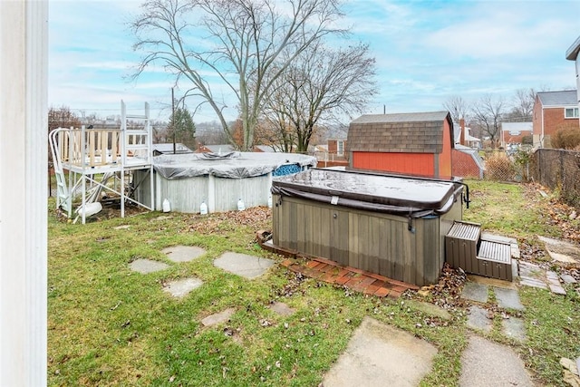 view of yard featuring a pool with hot tub