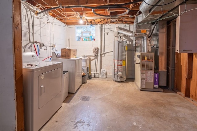 basement with washing machine and dryer, heating unit, and water heater