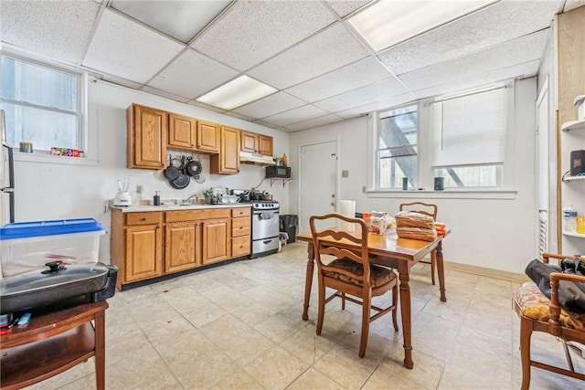 kitchen featuring a paneled ceiling, sink, and gas stove