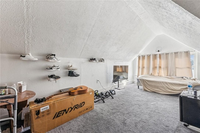 bedroom with lofted ceiling, a textured ceiling, and carpet flooring