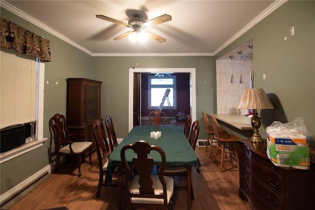 dining space featuring ceiling fan, a baseboard heating unit, dark hardwood / wood-style floors, and ornamental molding