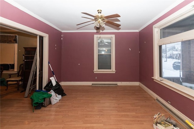 empty room featuring ceiling fan, crown molding, and light hardwood / wood-style flooring