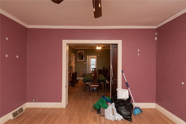 interior space featuring hardwood / wood-style flooring and ornamental molding