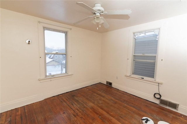 spare room featuring ceiling fan and dark hardwood / wood-style floors