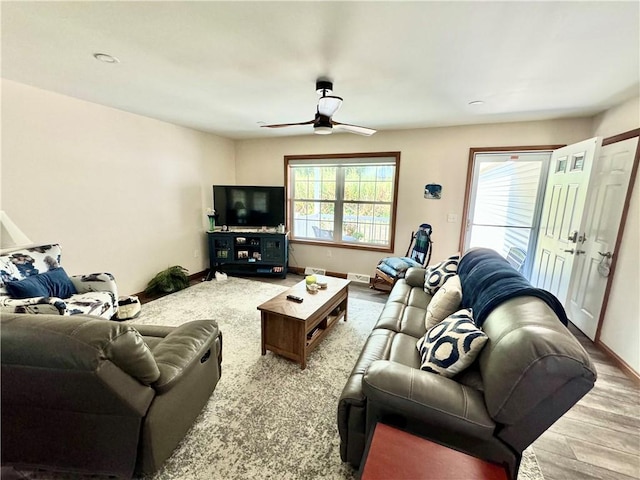 living room with ceiling fan, a healthy amount of sunlight, and hardwood / wood-style floors