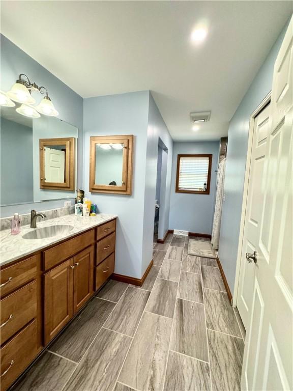 bathroom with vanity and curtained shower