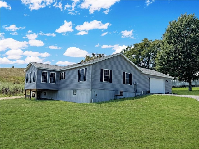 view of side of property with cooling unit, a yard, and a garage