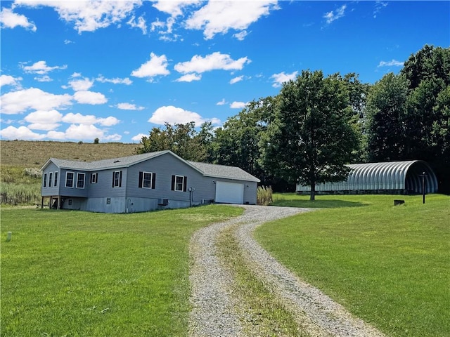 view of side of home with a garage, an outbuilding, and a lawn