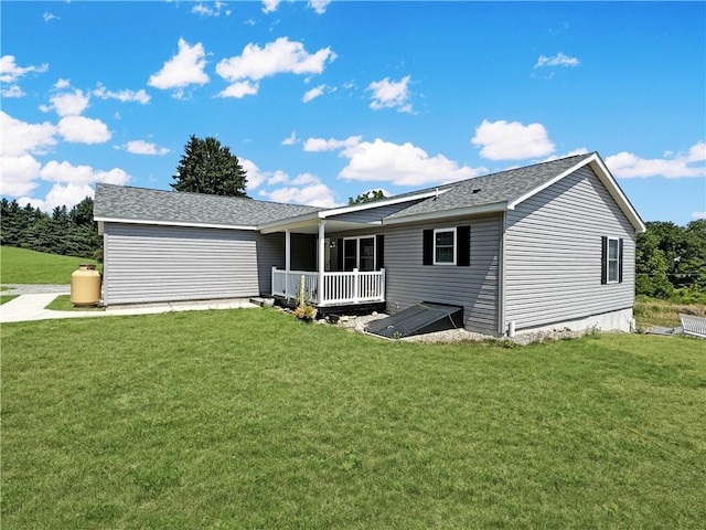 view of front of property with a deck and a front yard