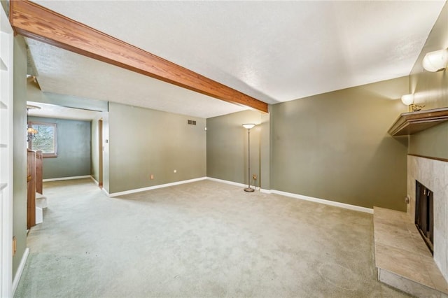 unfurnished living room featuring light carpet and beamed ceiling