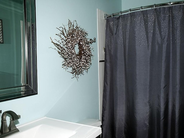 bathroom with sink, toilet, and a shower with shower curtain