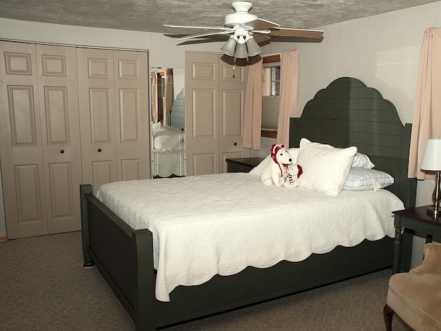 carpeted bedroom with ceiling fan and a textured ceiling