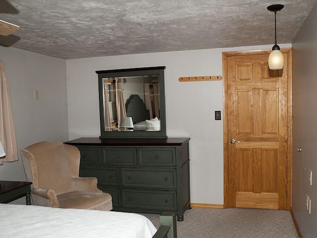 carpeted bedroom featuring a textured ceiling