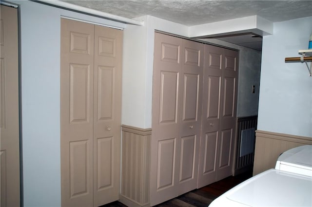 interior space with a textured ceiling and dark hardwood / wood-style flooring