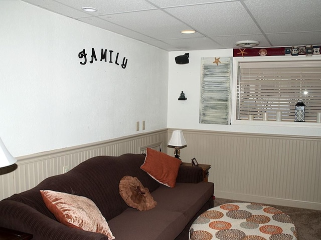 living room with carpet floors and a drop ceiling