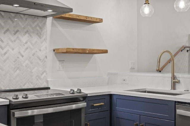 kitchen featuring hanging light fixtures, sink, blue cabinetry, and stainless steel appliances