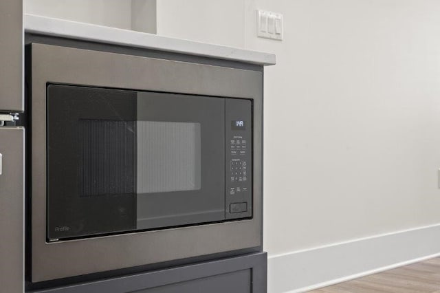 interior details featuring light hardwood / wood-style flooring and built in microwave