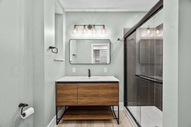 bathroom featuring walk in shower and vanity