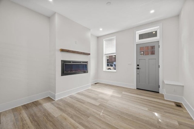 unfurnished living room featuring light hardwood / wood-style floors