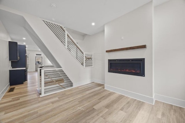 unfurnished living room featuring light hardwood / wood-style flooring