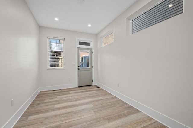 unfurnished room with light hardwood / wood-style floors