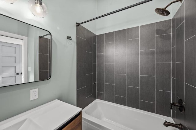 bathroom featuring tiled shower / bath combo and vanity