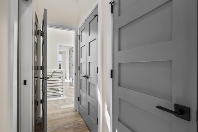 hallway with light hardwood / wood-style flooring