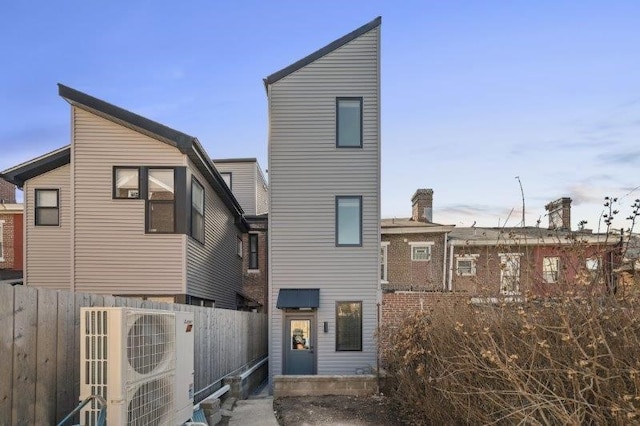 rear view of property featuring ac unit