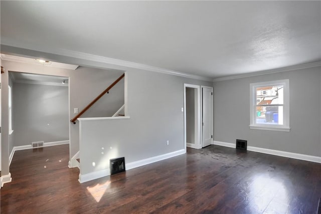 spare room featuring dark hardwood / wood-style flooring and crown molding