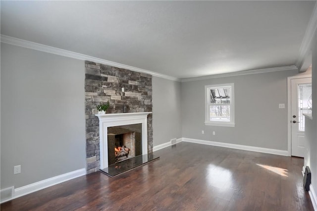 unfurnished living room featuring dark hardwood / wood-style floors, crown molding, and a fireplace