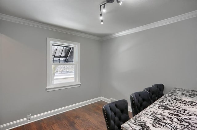 interior space with rail lighting, dark hardwood / wood-style floors, and crown molding