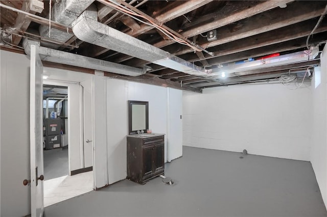 basement with heating unit and sink