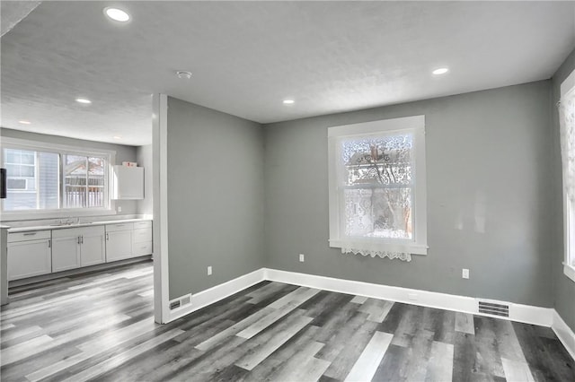 unfurnished dining area featuring hardwood / wood-style floors and sink