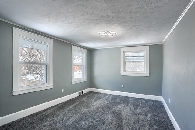 carpeted spare room with a textured ceiling and crown molding