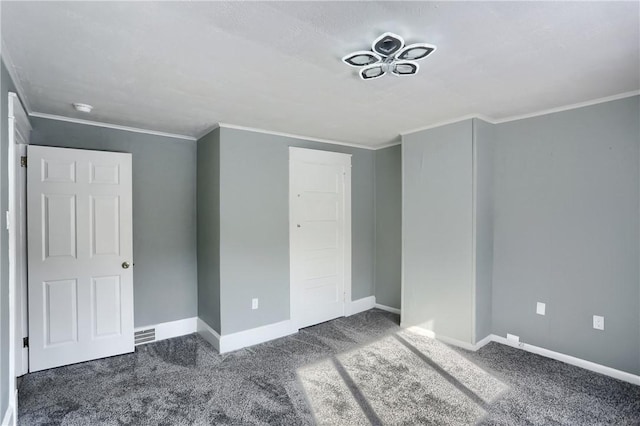 unfurnished bedroom with a closet, dark carpet, and ornamental molding