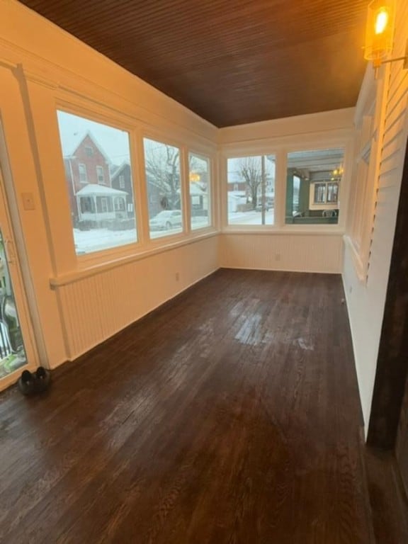 unfurnished sunroom featuring wood ceiling