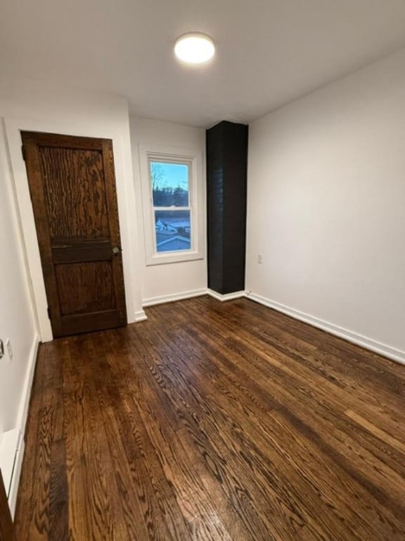 spare room featuring dark hardwood / wood-style flooring