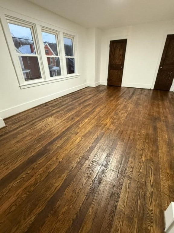 unfurnished room featuring dark wood-type flooring