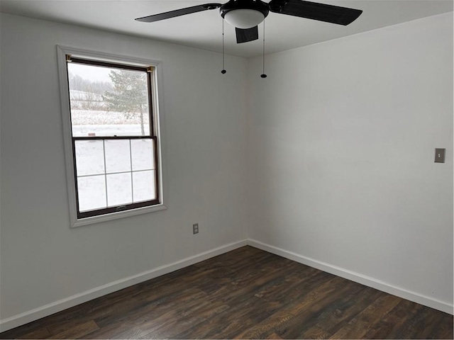 empty room featuring ceiling fan and dark hardwood / wood-style floors