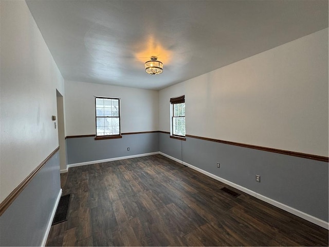 spare room featuring dark wood-type flooring