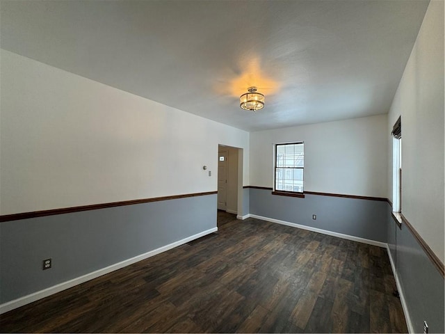 spare room featuring dark wood-type flooring