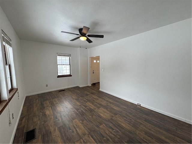 spare room with ceiling fan and dark hardwood / wood-style flooring