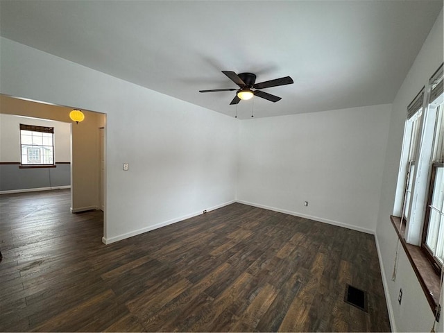 spare room featuring ceiling fan and dark hardwood / wood-style floors