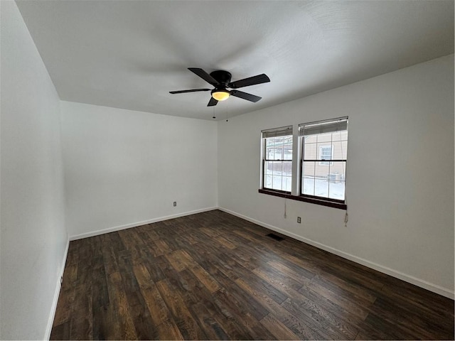 unfurnished room featuring ceiling fan and dark wood-type flooring