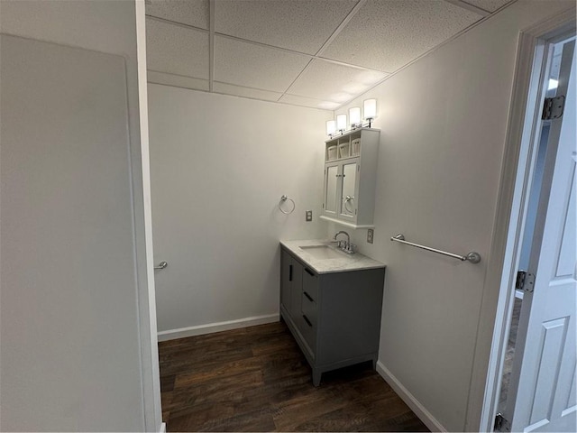 bathroom featuring hardwood / wood-style floors, a paneled ceiling, and vanity